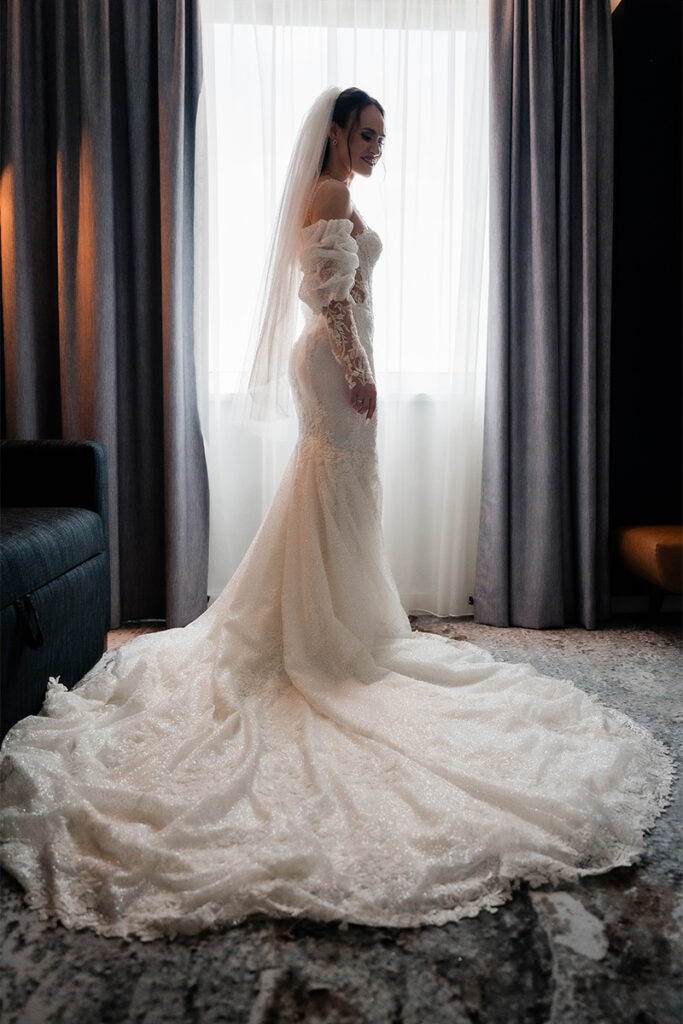 Hochzeitsfotograf Essen fotografiert eine wunderschöne Braut in ihrem Kleid am Fenster
