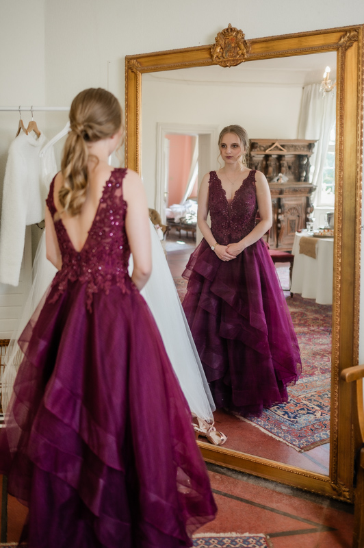 Hochzeitsfotograf Essen fotografiert eine junge Frau im Spiegel im roten Kleid